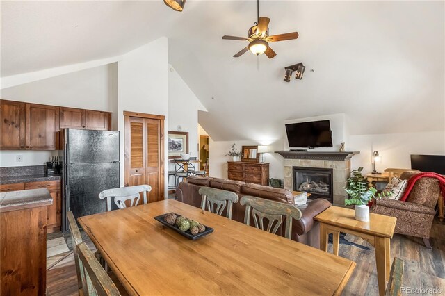 505 S Main St Unit 2207, Breckenridge, CO 80424 - dining space featuring ceiling fan, lofted ceiling, wood finished floors, and a fireplace