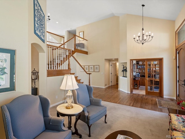 5700 S Benton Cir, Littleton, CO 80123 - entryway with high vaulted ceiling, stairway, a chandelier, wood finished floors, and baseboards