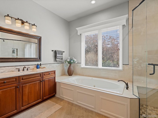 5700 S Benton Cir, Littleton, CO 80123 - full bathroom with a shower stall, a garden tub, wood finished floors, vanity, and recessed lighting
