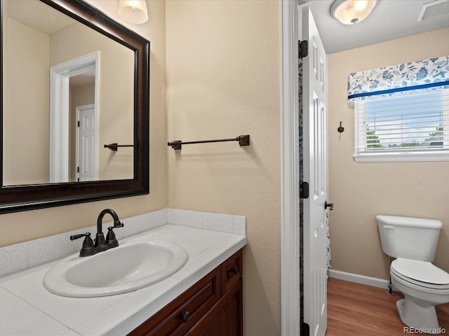 5700 S Benton Cir, Littleton, CO 80123 - bathroom with vanity, toilet, wood finished floors, and baseboards