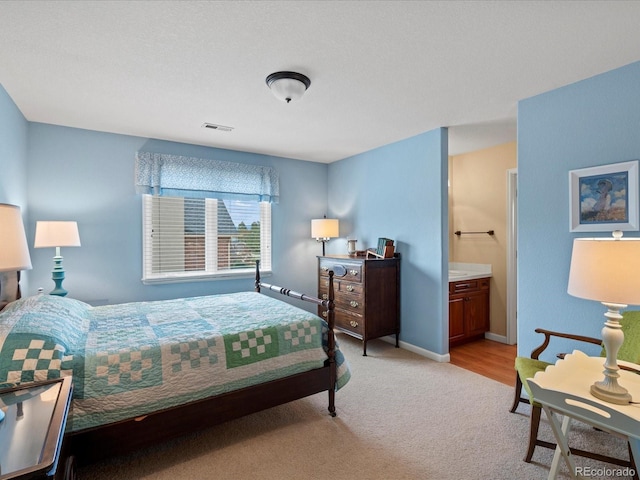 5700 S Benton Cir, Littleton, CO 80123 - bedroom with light carpet, connected bathroom, and baseboards