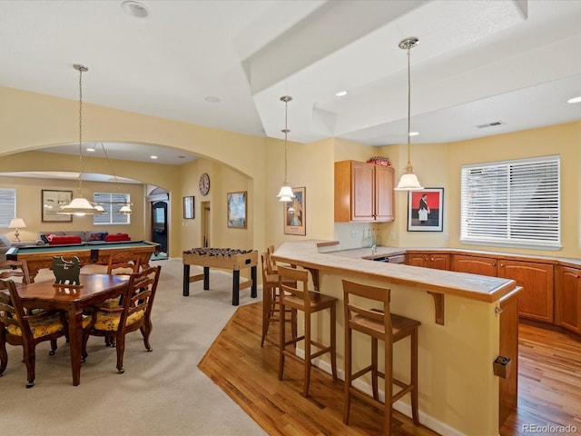 5700 S Benton Cir, Littleton, CO 80123 - kitchen with arched walkways, a kitchen breakfast bar, a peninsula, billiards, and pendant lighting