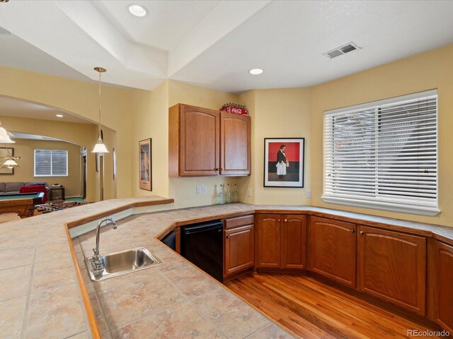 5700 S Benton Cir, Littleton, CO 80123 - kitchen with a sink, arched walkways, decorative light fixtures, light wood-style flooring, and a peninsula