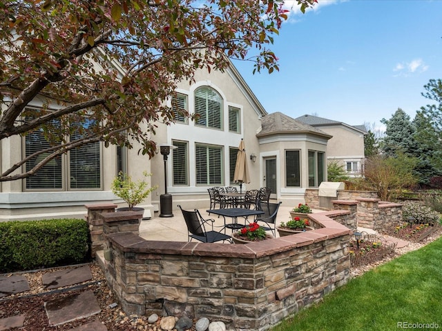 5700 S Benton Cir, Littleton, CO 80123 - rear view of property featuring stucco siding and a patio