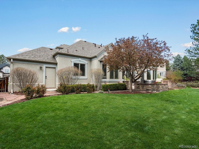 5700 S Benton Cir, Littleton, CO 80123 - view of front facade with stucco siding, roof with shingles, and a front yard