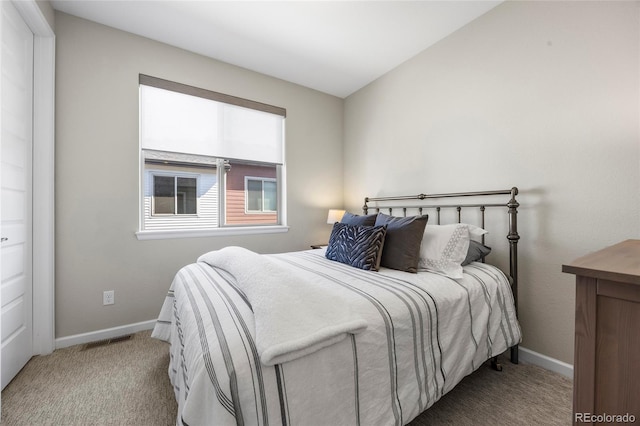 carpeted bedroom featuring baseboards and visible vents