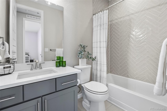 full bathroom featuring vanity, shower / tub combo with curtain, and toilet