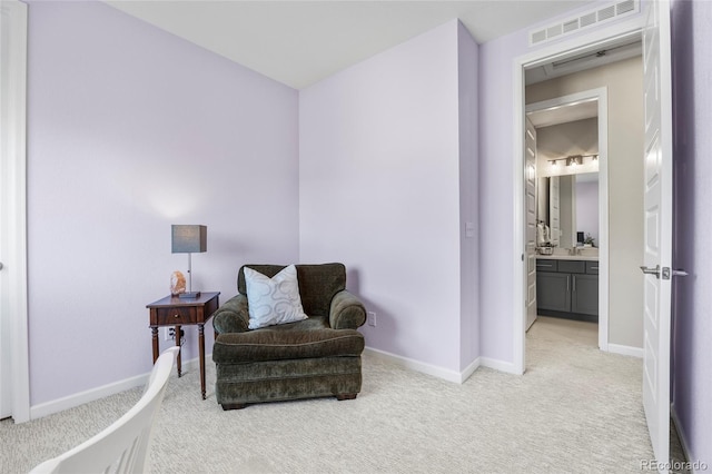 sitting room featuring baseboards, light carpet, and visible vents