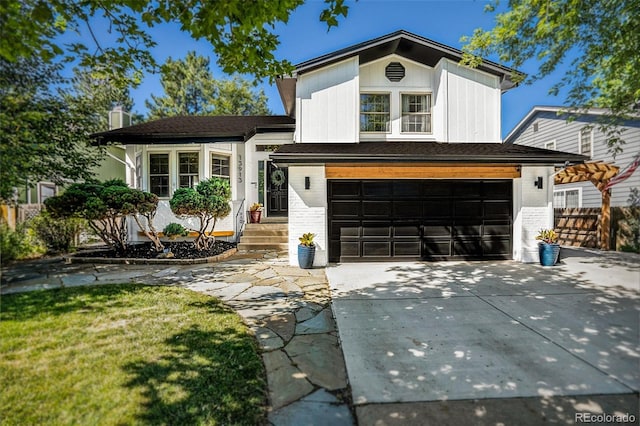 view of front of home featuring a garage and a front lawn