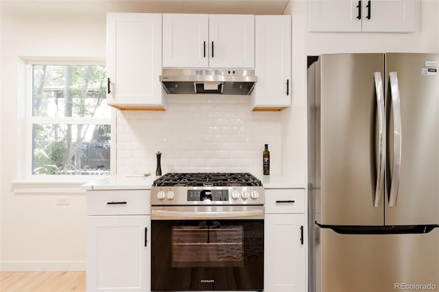 1361 W Custer Pl, Denver, CO 80223 - kitchen with stainless steel appliances, under cabinet range hood, decorative backsplash, white cabinets, and light countertops