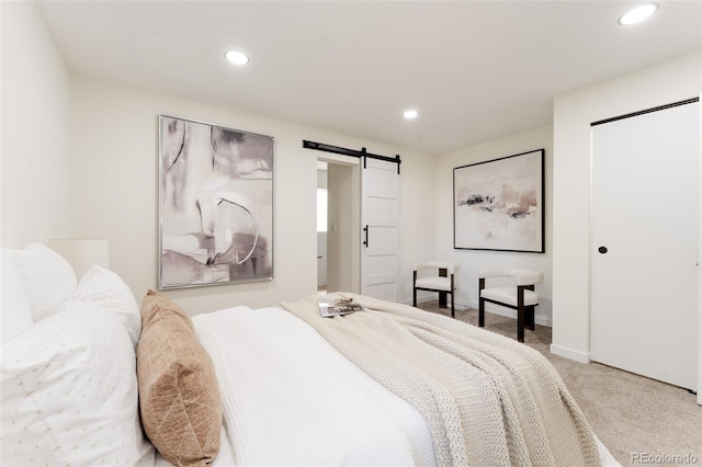 1361 W Custer Pl, Denver, CO 80223 - bedroom featuring a barn door, light colored carpet, recessed lighting, and a closet