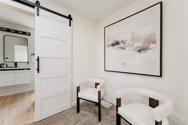 1361 W Custer Pl, Denver, CO 80223 - sitting room with a barn door and light colored carpet