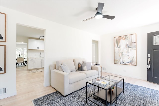 1361 W Custer Pl, Denver, CO 80223 - living room featuring ceiling fan and light wood finished floors