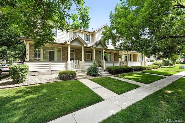 1325 W 112th Ave Unit B, Westminster, CO 80234 - view of front of home featuring brick siding, a porch, and a front yard