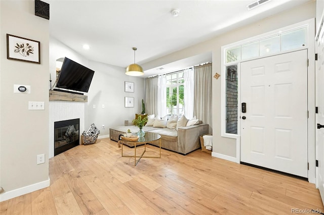 1325 W 112th Ave Unit B, Westminster, CO 80234 - living room with light wood-type flooring, a tiled fireplace, and recessed lighting