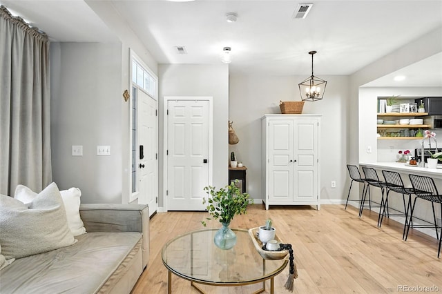 1325 W 112th Ave Unit B, Westminster, CO 80234 - living area featuring light wood-style flooring and a chandelier