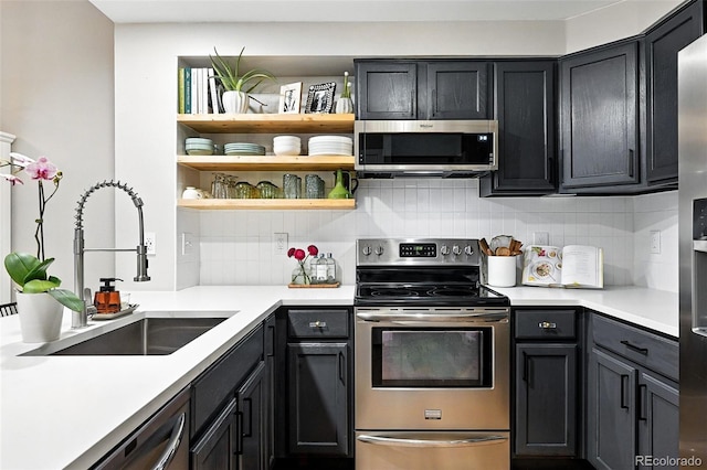 1325 W 112th Ave Unit B, Westminster, CO 80234 - kitchen with appliances with stainless steel finishes, decorative backsplash, light countertops, and open shelves