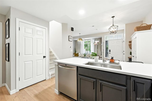 1325 W 112th Ave Unit B, Westminster, CO 80234 - kitchen featuring dishwasher, light wood-style flooring, light countertops, and decorative light fixtures