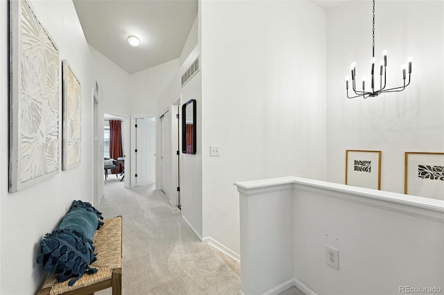 1325 W 112th Ave Unit B, Westminster, CO 80234 - hall featuring light colored carpet, a chandelier, and a high ceiling