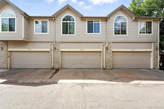 1325 W 112th Ave Unit B, Westminster, CO 80234 - multi unit property with a garage, driveway, and brick siding