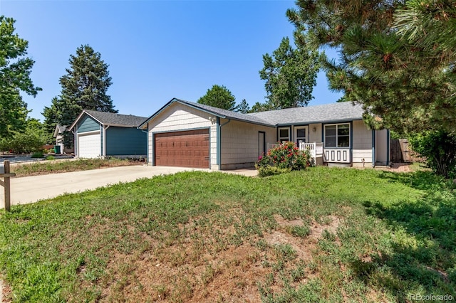 3735 S Lewiston St, Aurora, CO 80013 - single story home with a porch, an attached garage, driveway, and a front lawn