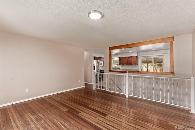 3735 S Lewiston St, Aurora, CO 80013 - unfurnished living room with wood finished floors and a textured ceiling