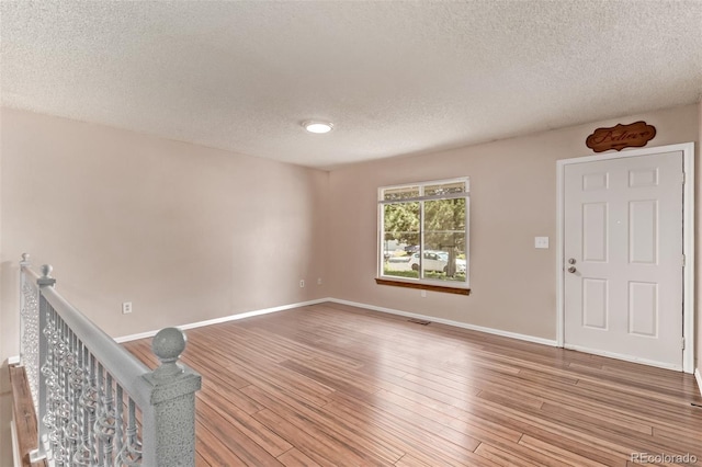 3735 S Lewiston St, Aurora, CO 80013 - spare room with a textured ceiling and light wood-type flooring