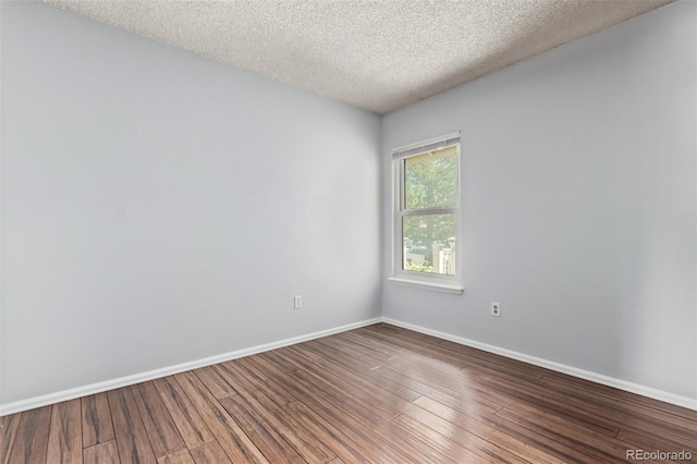 3735 S Lewiston St, Aurora, CO 80013 - unfurnished room featuring wood finished floors and a textured ceiling