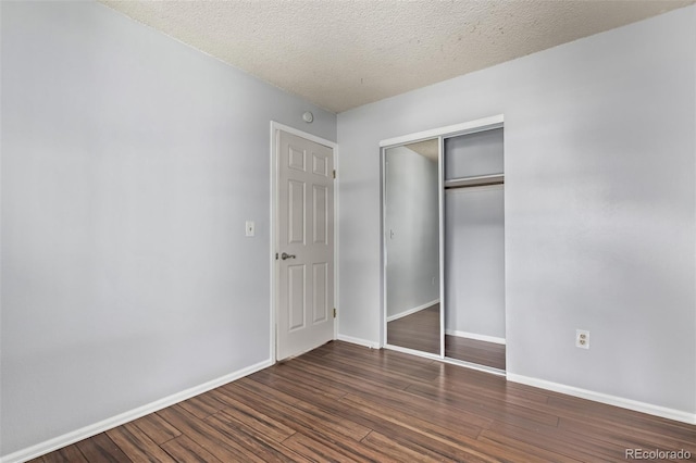 3735 S Lewiston St, Aurora, CO 80013 - unfurnished bedroom with wood finished floors, a closet, and a textured ceiling