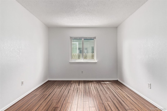 3735 S Lewiston St, Aurora, CO 80013 - spare room featuring wood finished floors and a textured ceiling