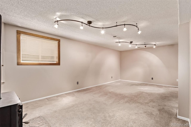 3735 S Lewiston St, Aurora, CO 80013 - empty room featuring light carpet, a textured ceiling, and track lighting