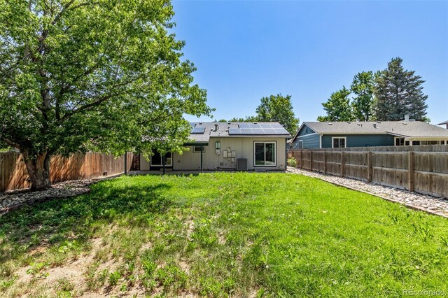 3735 S Lewiston St, Aurora, CO 80013 - back of house with roof mounted solar panels and a fenced backyard