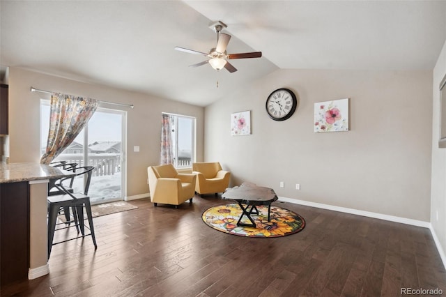 sitting room featuring dark hardwood / wood-style flooring, vaulted ceiling, and ceiling fan