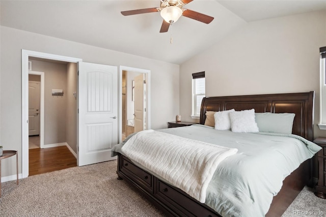 bedroom featuring lofted ceiling, light colored carpet, ceiling fan, and ensuite bath