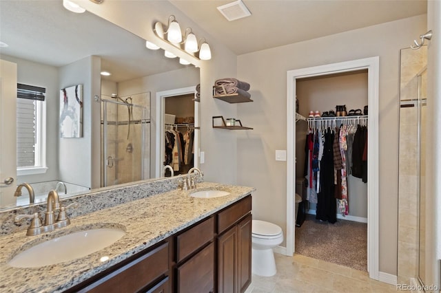 bathroom featuring walk in shower, toilet, vanity, and tile patterned floors