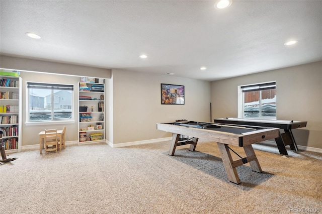 recreation room featuring a textured ceiling and carpet floors