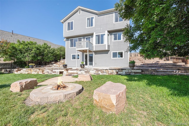 6833 E 115th Ave, Thornton, CO 80233 - back of property with a balcony, a fire pit, and a patio