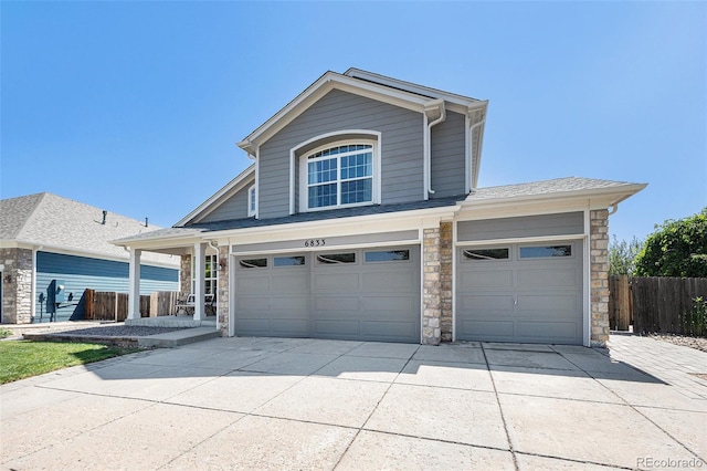 6833 E 115th Ave, Thornton, CO 80233 - traditional-style house featuring stone siding, concrete driveway, and a garage