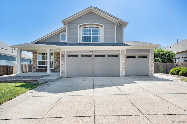 6833 E 115th Ave, Thornton, CO 80233 - traditional-style home with a porch, stone siding, concrete driveway, an attached garage, and roof with shingles
