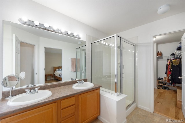 6833 E 115th Ave, Thornton, CO 80233 - ensuite bathroom with a stall shower, double vanity, a spacious closet, and tile patterned flooring