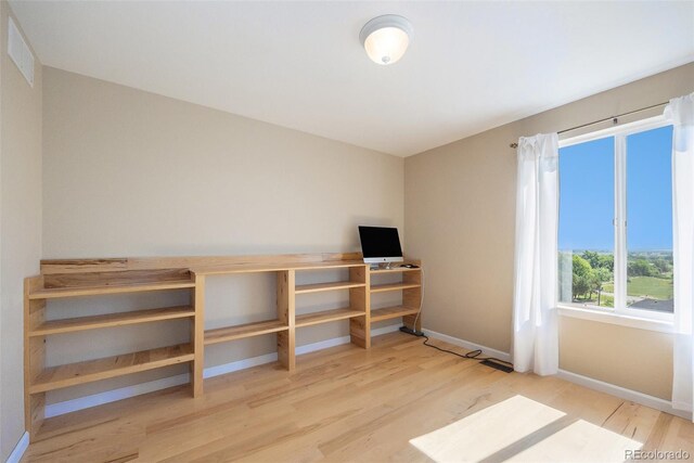 6833 E 115th Ave, Thornton, CO 80233 - unfurnished bedroom featuring wood finished floors and baseboards