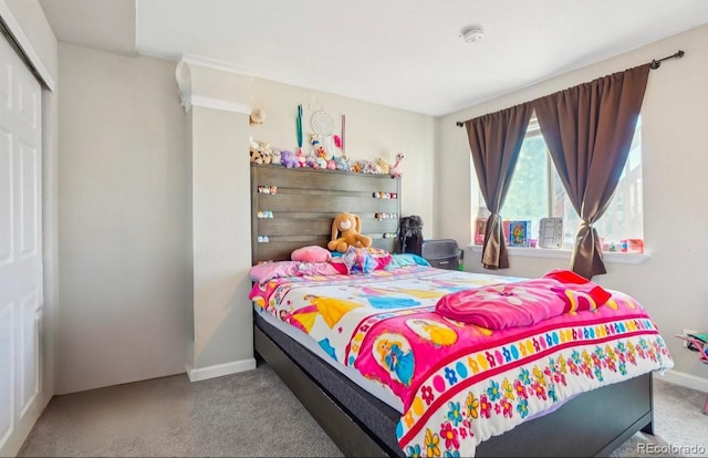 bedroom featuring a closet and light carpet