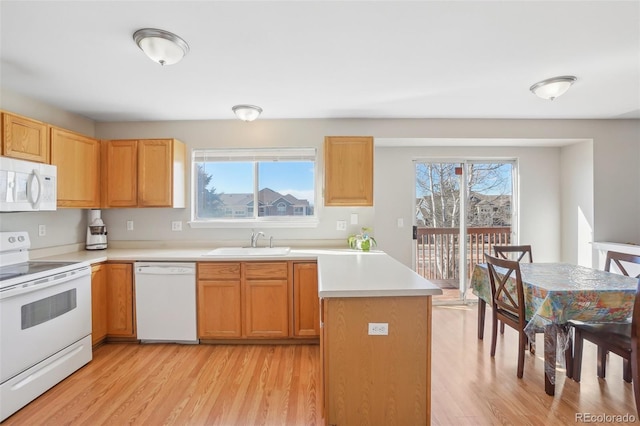 kitchen featuring white appliances, sink, and light wood-type flooring