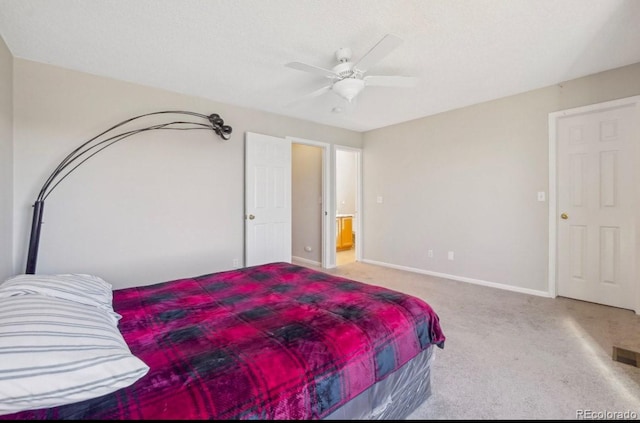 carpeted bedroom featuring ceiling fan and a textured ceiling