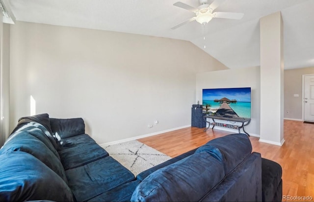 living room featuring lofted ceiling, hardwood / wood-style floors, and ceiling fan