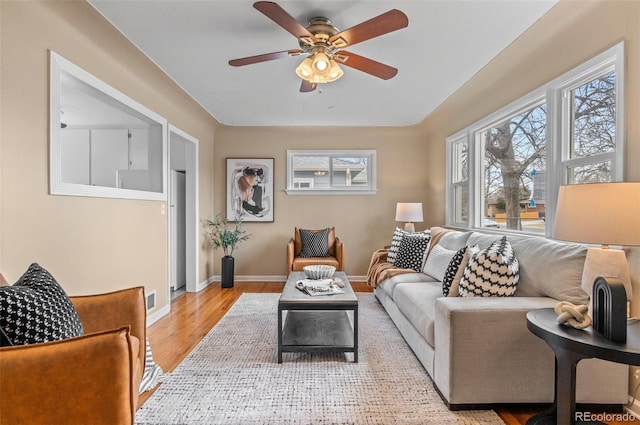 2248 Lima St, Aurora, CO 80010 - living room featuring light wood-style flooring, ceiling fan, and baseboards