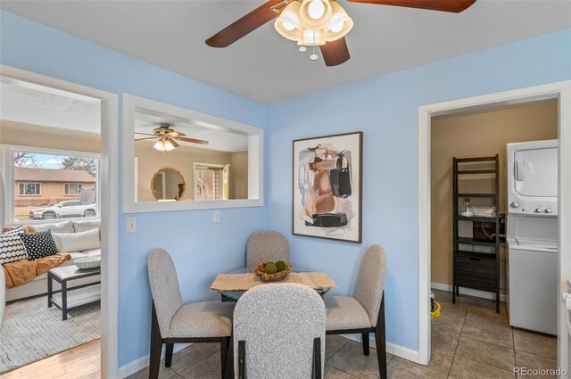 2248 Lima St, Aurora, CO 80010 - dining area with estacked washer and dryer, a ceiling fan, and baseboards