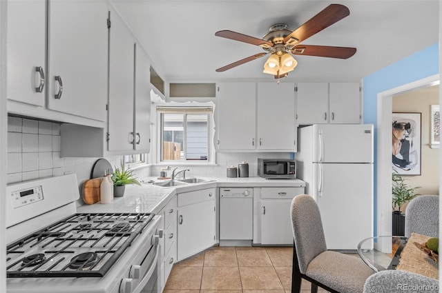 2248 Lima St, Aurora, CO 80010 - kitchen featuring white appliances, a ceiling fan, backsplash, light countertops, and light tile patterned floors
