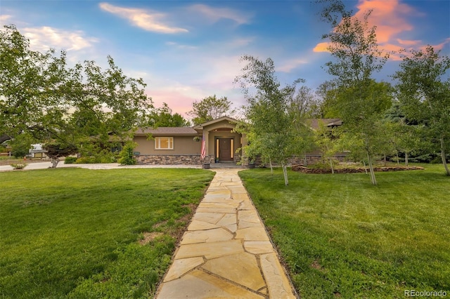 10380 W Warren Ave, Lakewood, CO 80227 - view of front of home with stone siding, stucco siding, and a front yard