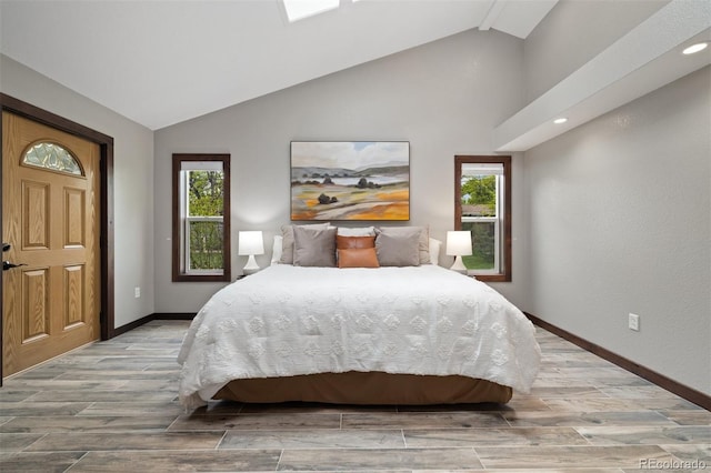 10380 W Warren Ave, Lakewood, CO 80227 - bedroom featuring lofted ceiling, light wood-style floors, multiple windows, and recessed lighting